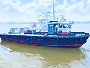 Small vessel named "Little Ray" on water, part of the Original Fleet, featuring black tires along its sides, a red and black hull, and equipment on the upper deck.